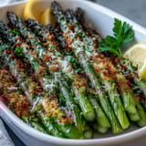 Tender asparagus coated in a golden panko and Asiago crust, baked until crispy and finished with fresh parsley.