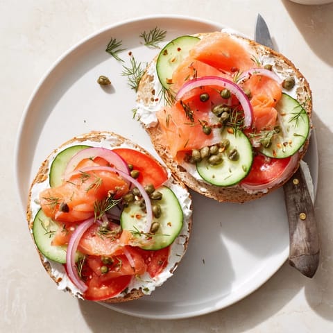 Golden brown bagel halves generously spread with cream cheese and garnished with capers.