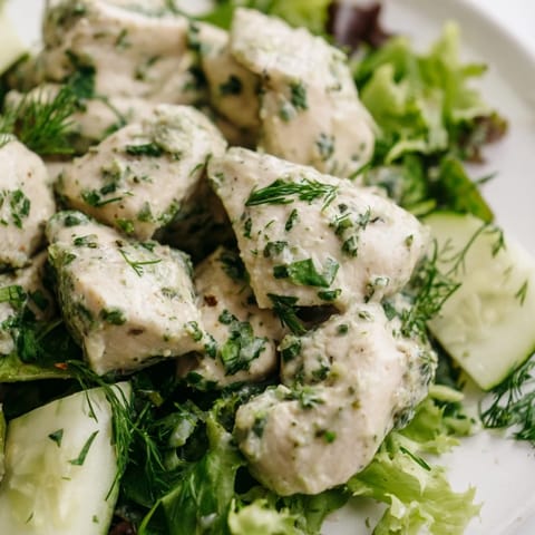 Perfectly cooked Green Goddess Chicken Salad served with juicy cherry tomatoes and cucumber slices, ideal for a light lunch or healthy dinner.