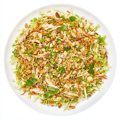 Freshly shredded cabbage, tender rotisserie chicken, and crushed ramen noodles tossed in a sweet sesame dressing in a vibrant bowl.