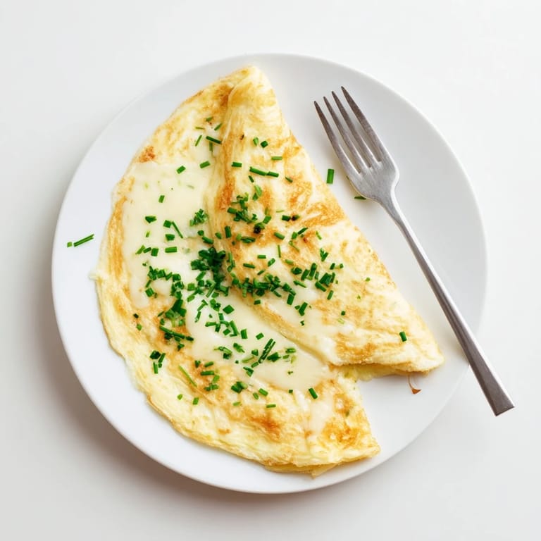 Steamy homemade omelet with gooey melted cheddar, ready to eat with a fork and napkin.