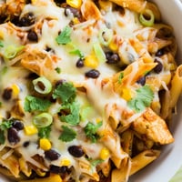 Golden, crispy chicken pieces and melted cheese top this hearty Crispy Chicken Burrito Pasta in a skillet.