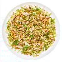 Freshly shredded cabbage, tender rotisserie chicken, and crushed ramen noodles tossed in a sweet sesame dressing in a vibrant bowl.