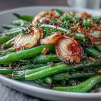 Roasted garlic green beans with golden caramelized garlic and bright lemon zest for a savory Easter side.  